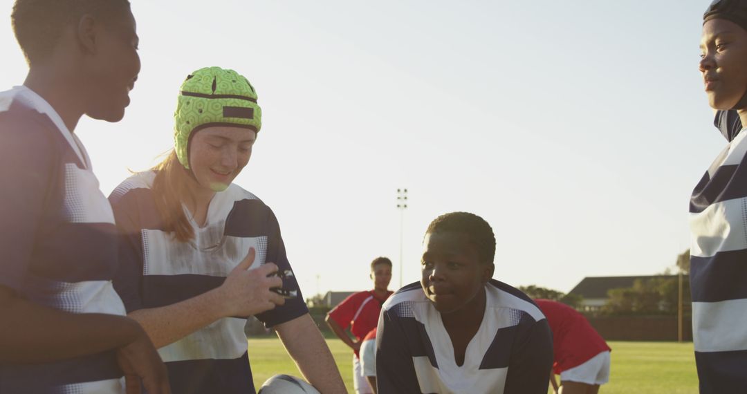 Youth Rugby Team Huddling During Training Session at Sunset - Free Images, Stock Photos and Pictures on Pikwizard.com