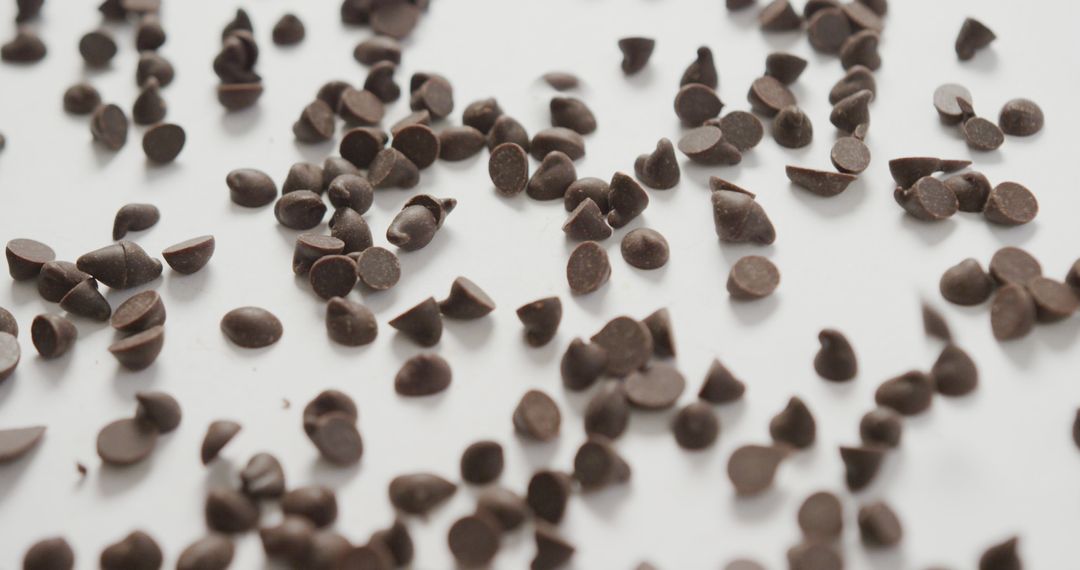 Scattered Chocolate Chips on White Surface