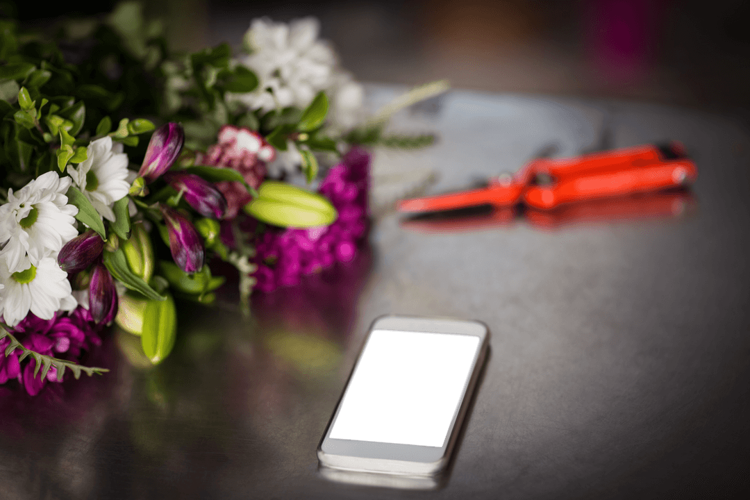 Transparent Mobile Screen on Table with Fresh Garden Flowers