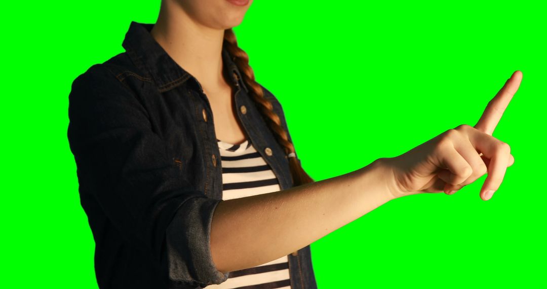 Young Woman Using Virtual Touchscreen Interface on Green Background - Free Images, Stock Photos and Pictures on Pikwizard.com