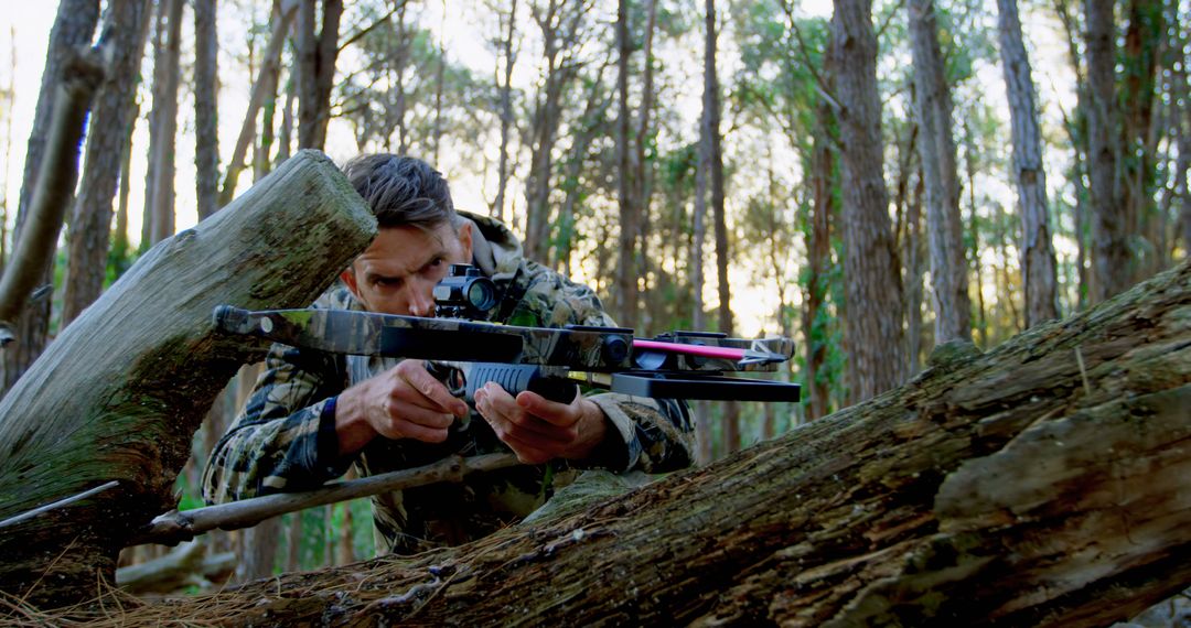 Hunter In Camouflage Aiming Crossbow In Forest - Free Images, Stock Photos and Pictures on Pikwizard.com