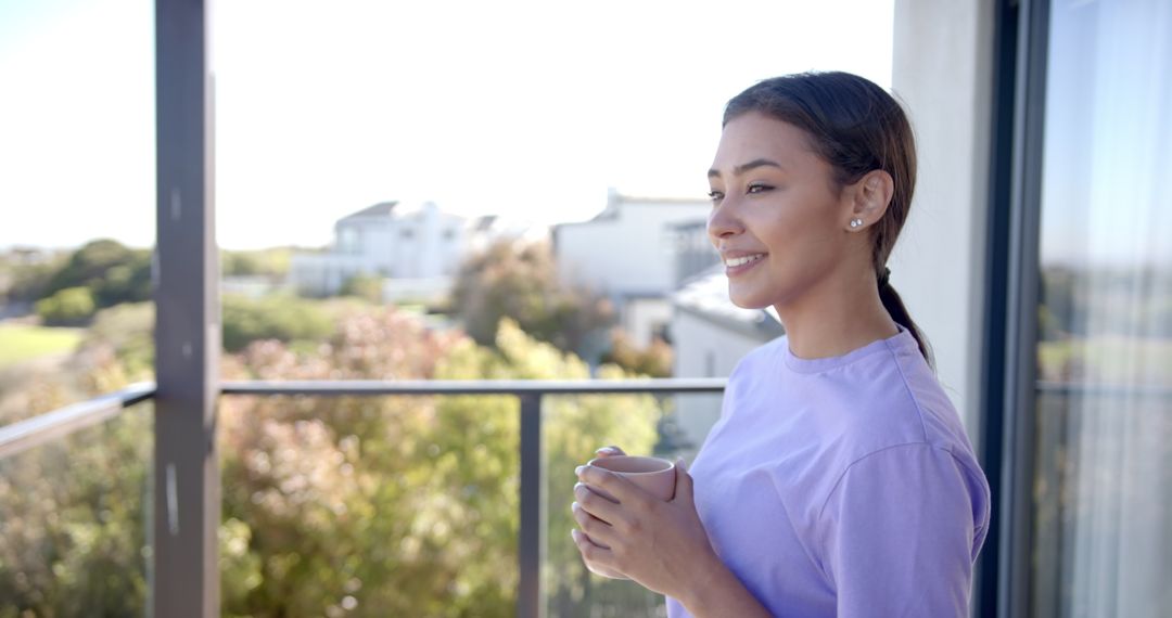 Smiling Woman Relaxing with Morning Coffee on Home Balcony