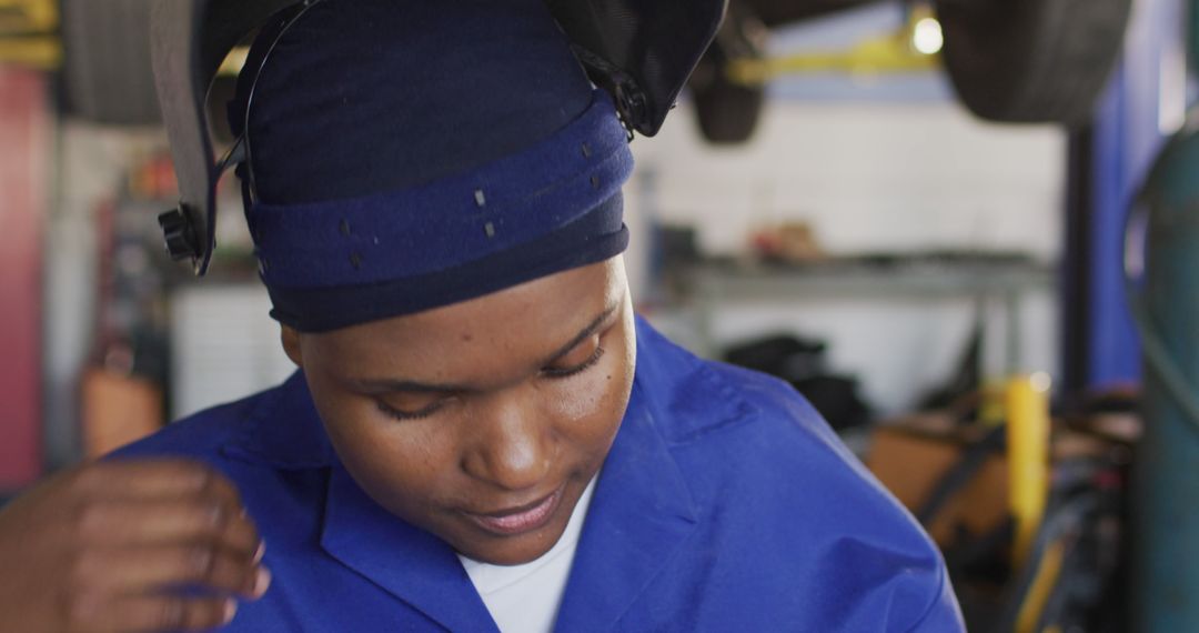 Female Auto Mechanic in Workshop Wearing Protective Gear - Free Images, Stock Photos and Pictures on Pikwizard.com