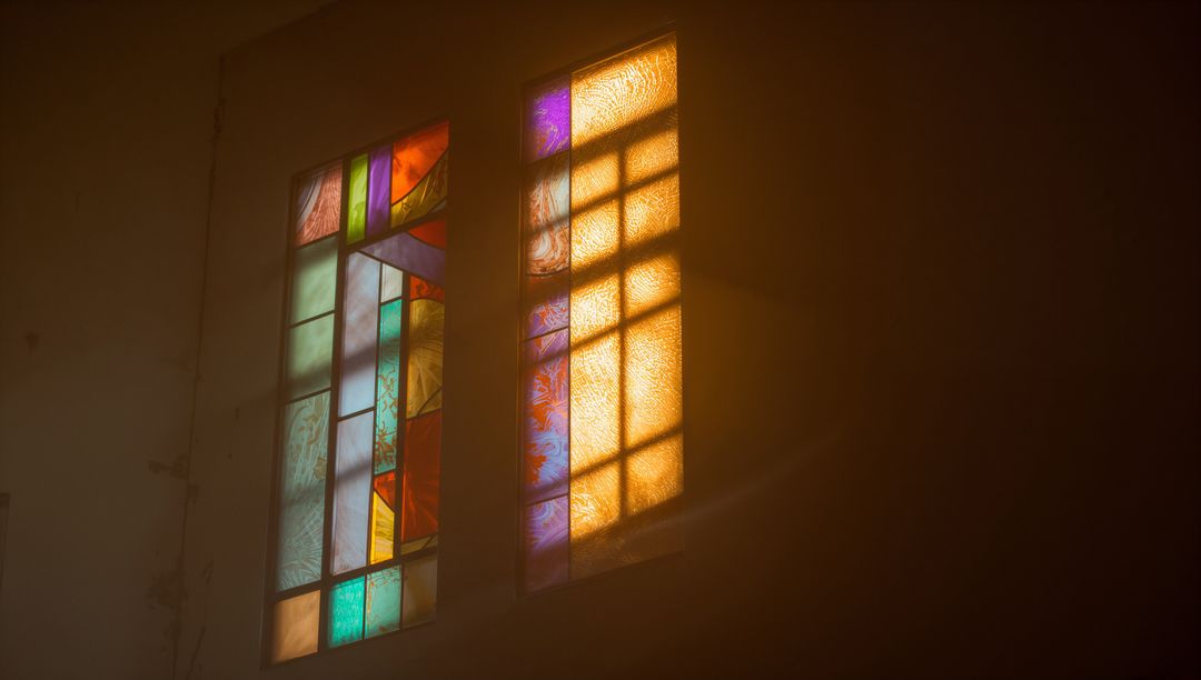 Sunlit Stained-Glass Creates Mesmerizing Patterns on Chapel Wall