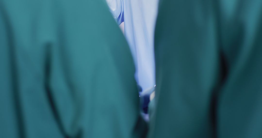 Medical Team Wearing Surgical Gowns in Operating Room - Free Images, Stock Photos and Pictures on Pikwizard.com