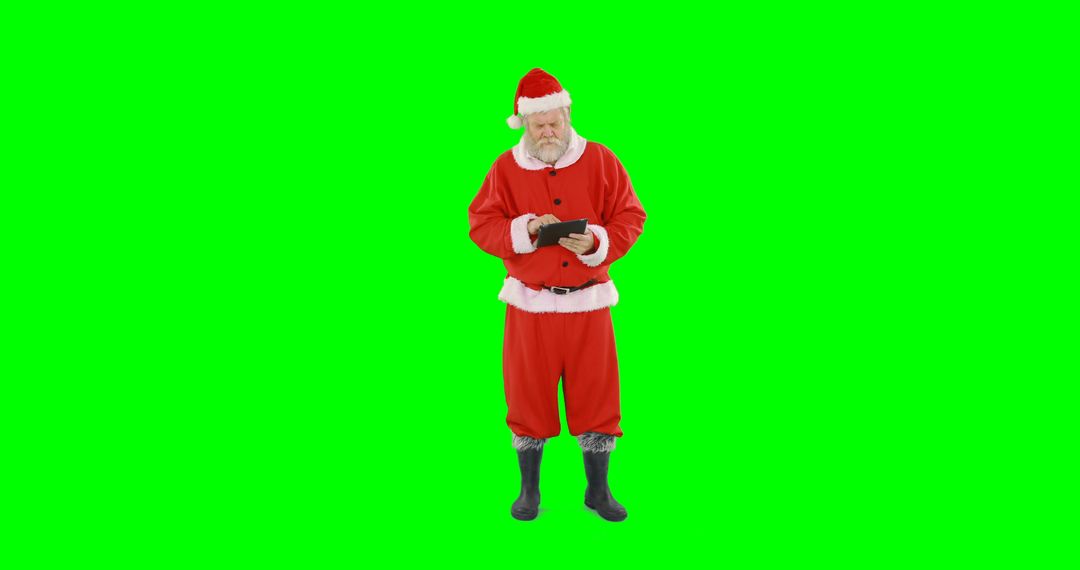 Santa Claus using tablet against green screen background - Free Images, Stock Photos and Pictures on Pikwizard.com