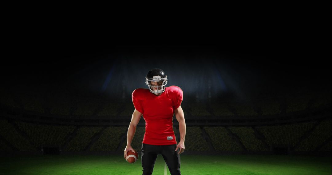 Determined American Football Player in Red Jersey on Field at Night
