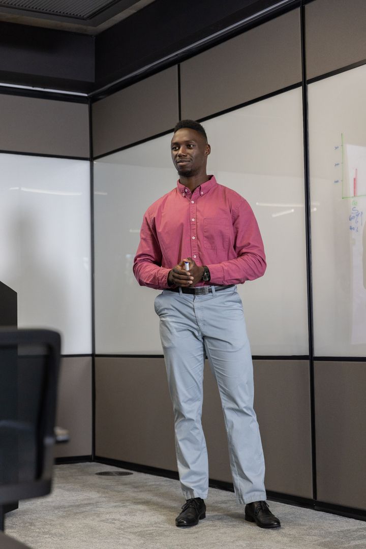 Confident Man Presenting in Modern Office Setting