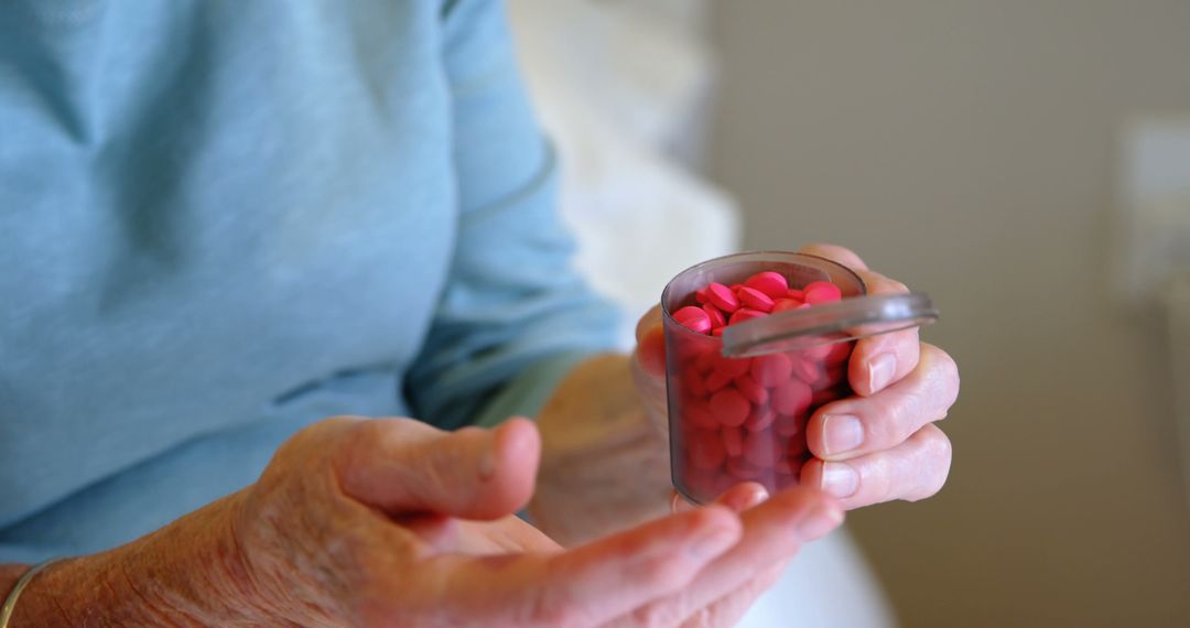 Elderly Person Holding Pill Container with Red Pills - Free Images, Stock Photos and Pictures on Pikwizard.com