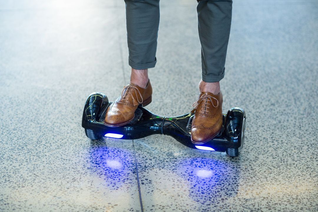 Businessman Riding Hoverboard in Office - Free Images, Stock Photos and Pictures on Pikwizard.com