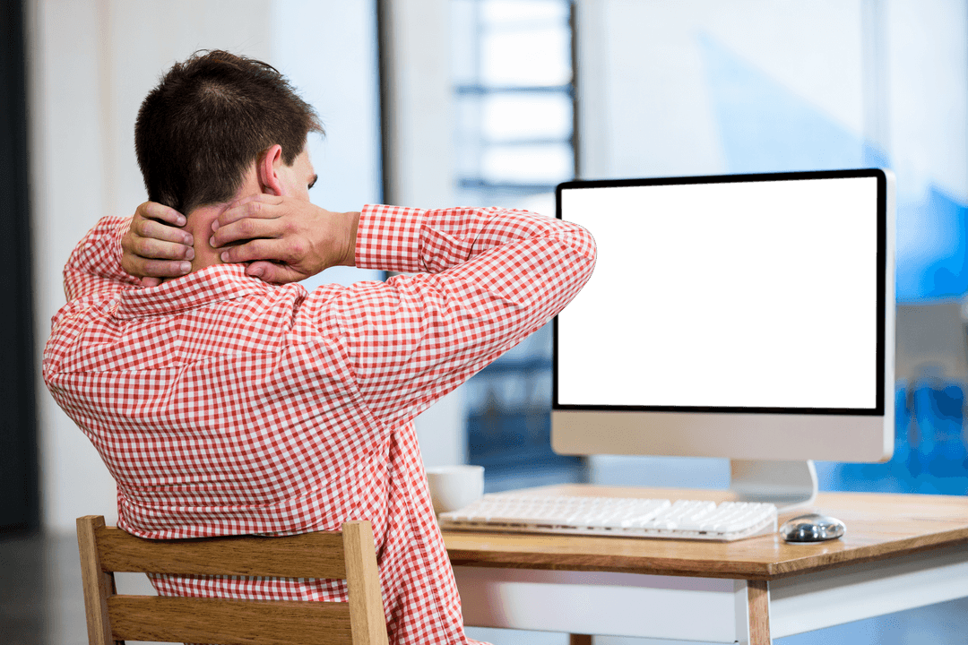 Businessman Massaging Neck While Taking a Break at Desk