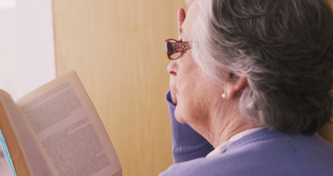 Elderly Woman Reading Book at Home - Free Images, Stock Photos and Pictures on Pikwizard.com