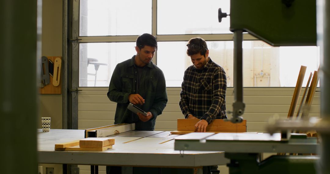 Two Male Workshop Workers Discussing Woodworking Project - Free Images, Stock Photos and Pictures on Pikwizard.com