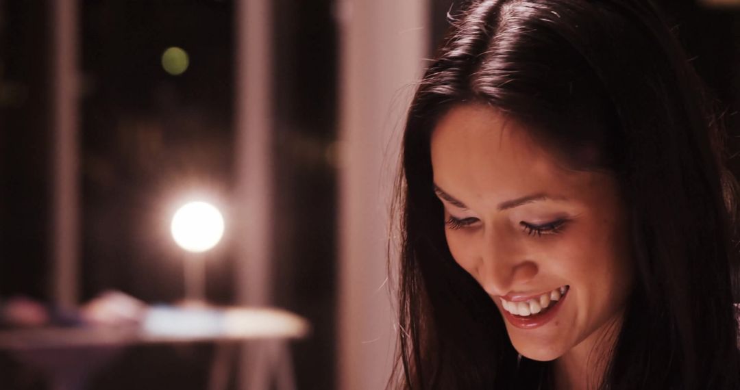 Serene Woman Smiling Under Soft Lighting