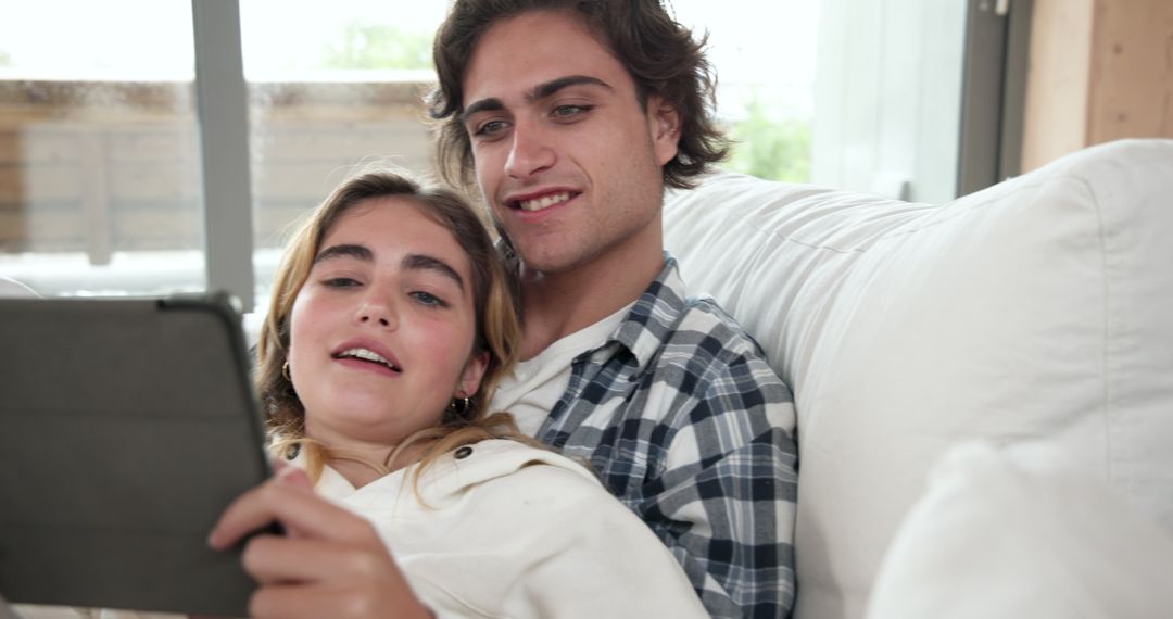 Young Couple Relaxing at Home Together with Digital Tablet