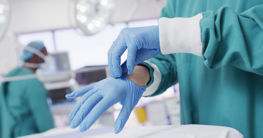 Doctor Putting on Surgical Gloves in Operating Room - Free Images, Stock Photos and Pictures on Pikwizard.com