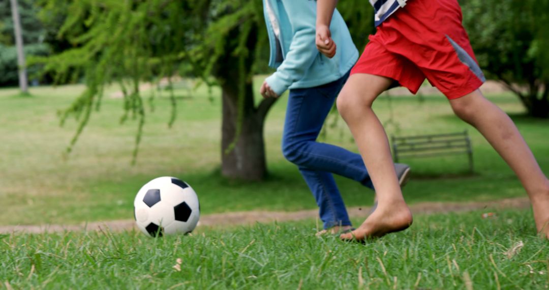 Children Playing Soccer Outdoors Barefoot on Grass - Free Images, Stock Photos and Pictures on Pikwizard.com