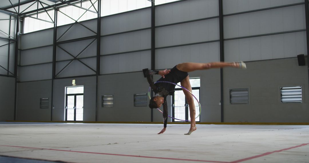 Young Gymnast Performing Floor Routine with Hoop in Large Indoor Gym - Free Images, Stock Photos and Pictures on Pikwizard.com