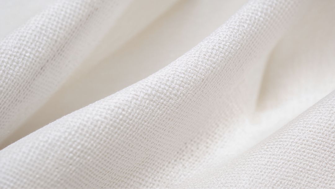 White Woven Textile Showing Fine Weave and Soft Folds for Backgrounds