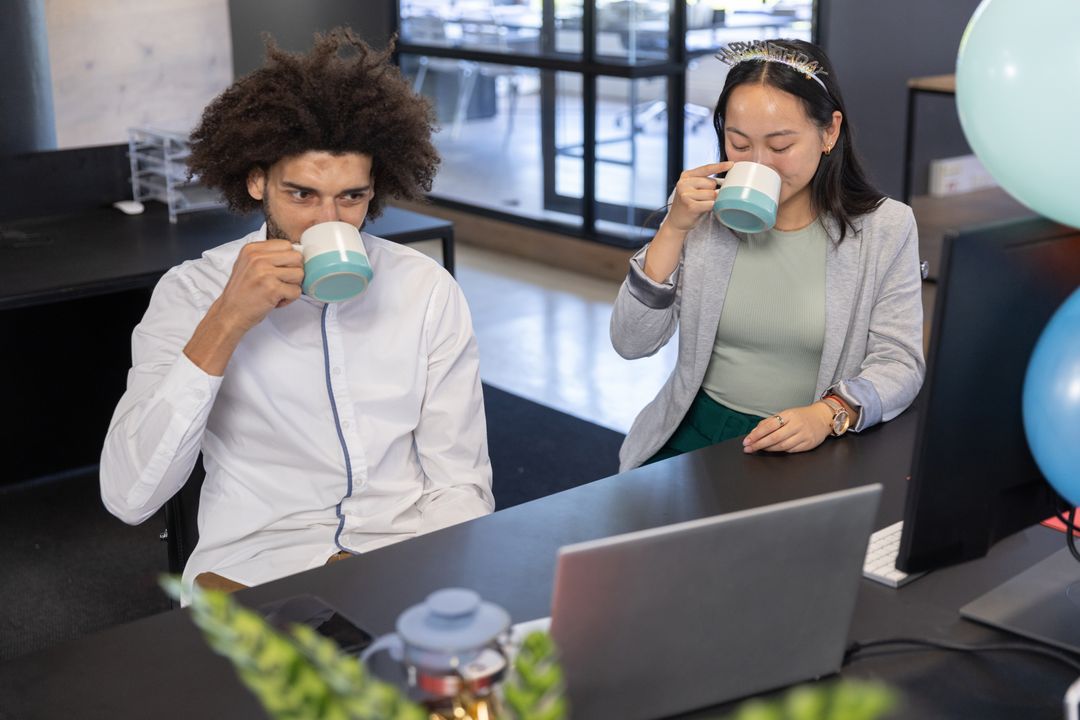 Diverse Coworkers Enjoying Coffee in Open-Plan Office