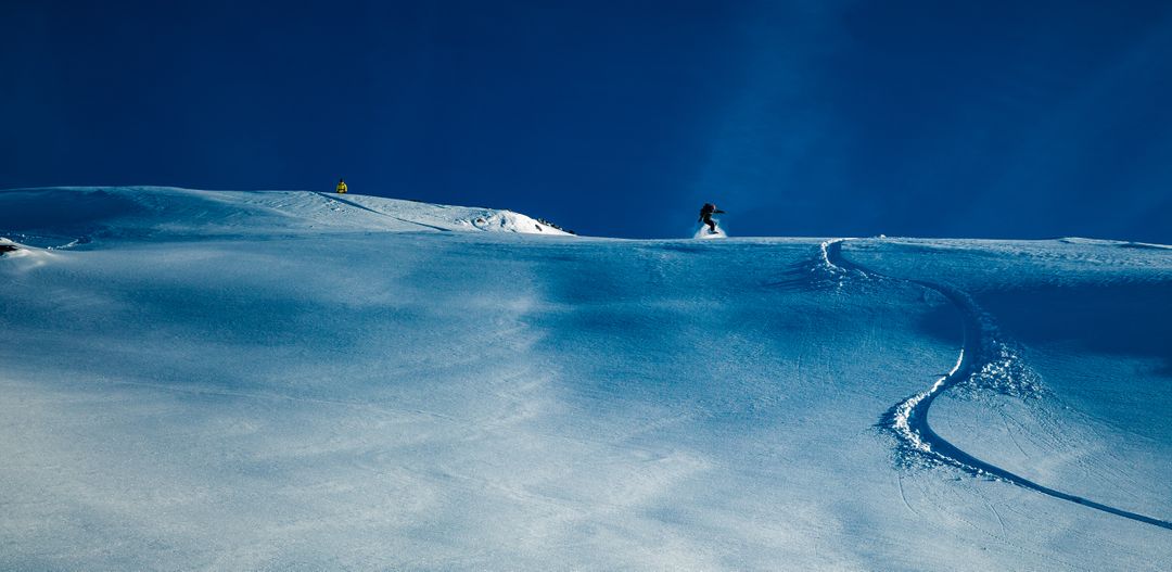 Snowboarders Gliding on Fresh Powder Snow in Alps - Free Images, Stock Photos and Pictures on Pikwizard.com