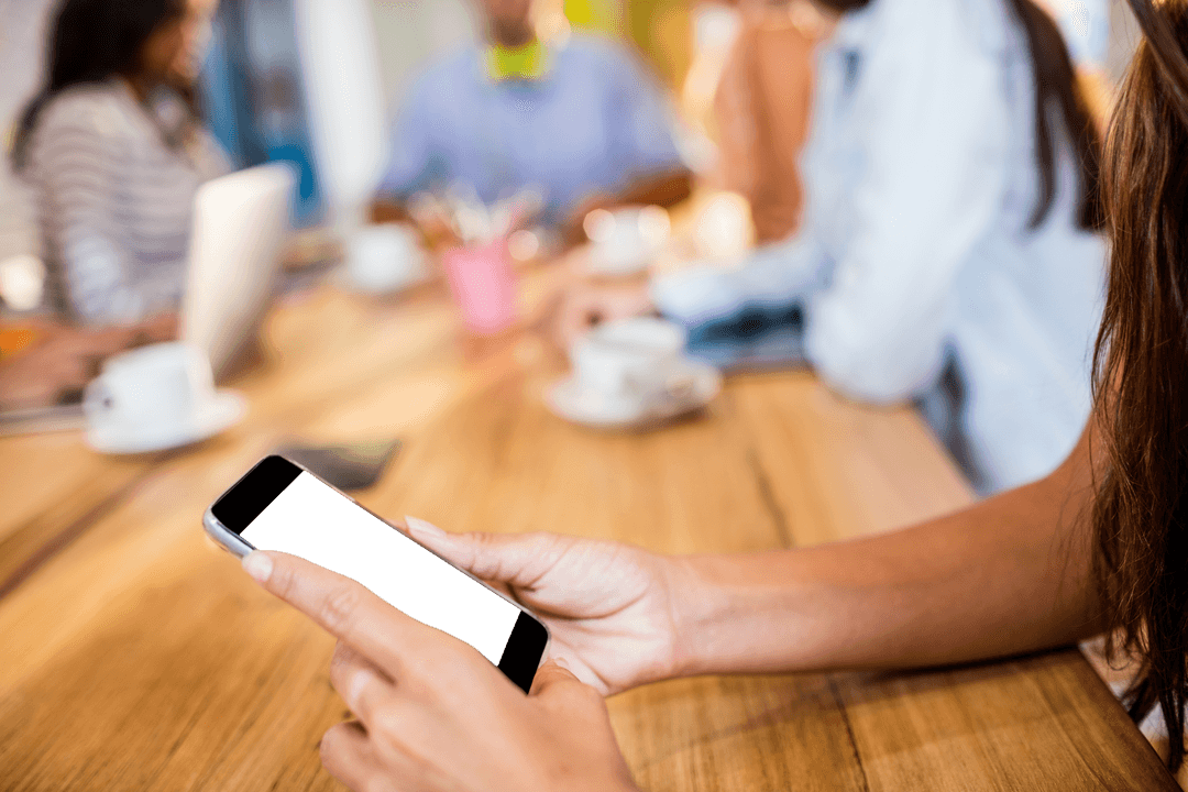 Businesswoman Using Transparent Smartphone at Workflow Meeting