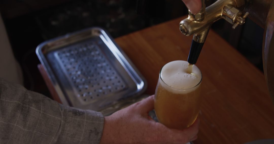 Brewery Worker Pouring Fresh Beer into Glass