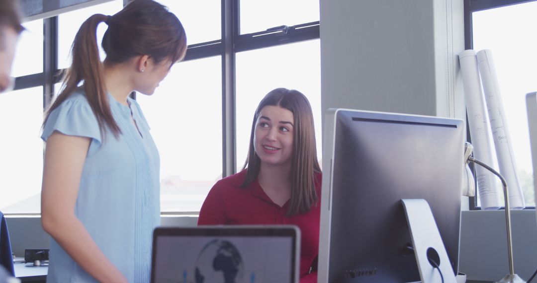 Two Women Collaborating in Modern Office - Free Images, Stock Photos and Pictures on Pikwizard.com