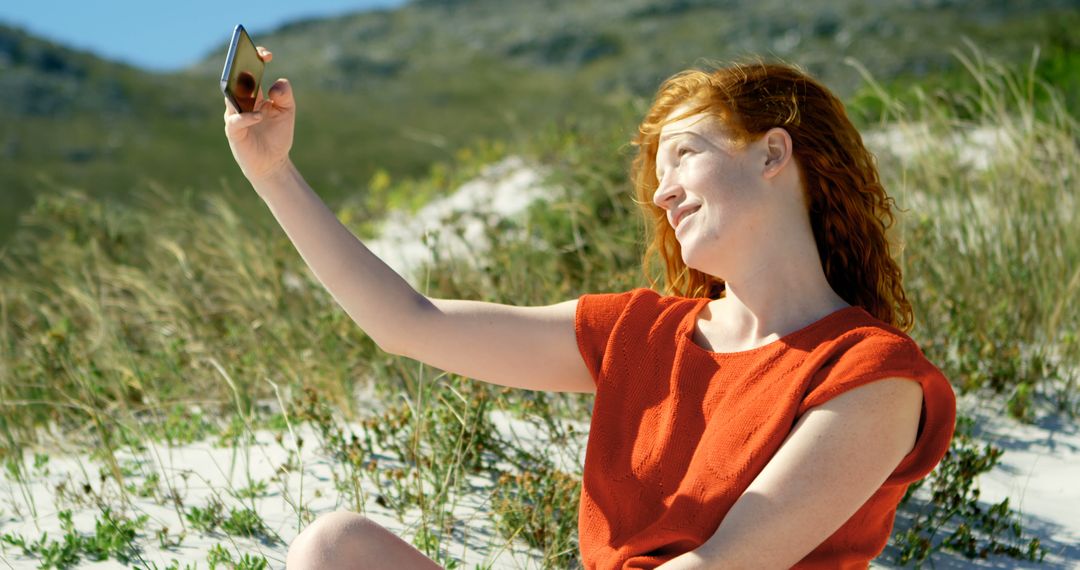 Woman Enjoying Selfie Outdoors on Sand Dunes - Free Images, Stock Photos and Pictures on Pikwizard.com