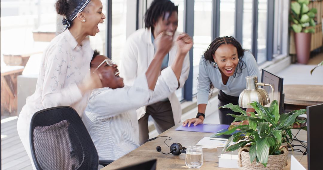 Team Celebrates Success Happily in Modern Office Environment