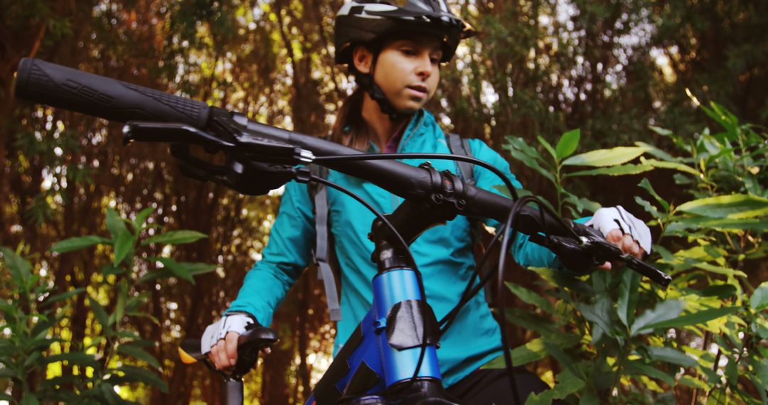 Female Cyclist Pausing During Mountain Bike Ride in Forest - Free Images, Stock Photos and Pictures on Pikwizard.com