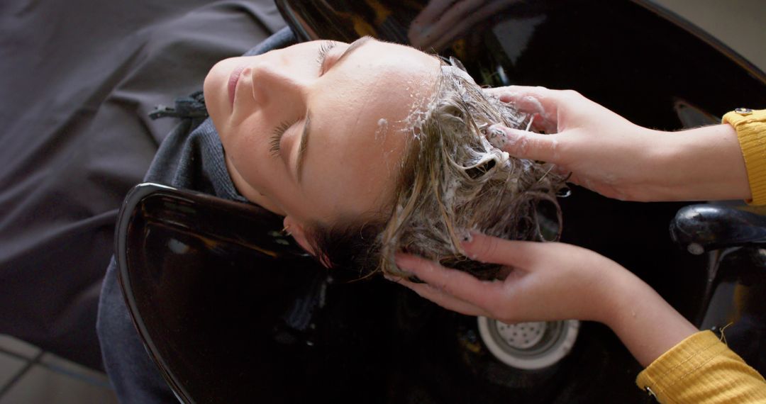 Woman Relaxing While Hairdresser Washing Hair at Salon - Free Images, Stock Photos and Pictures on Pikwizard.com