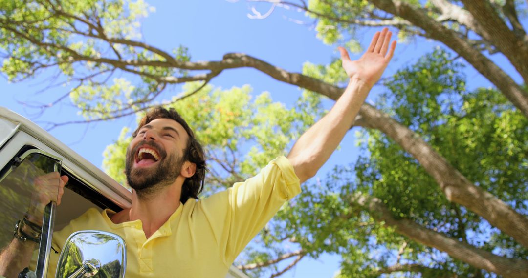 Cheerful Man Enjoying Road Trip under the Sun - Free Images, Stock Photos and Pictures on Pikwizard.com