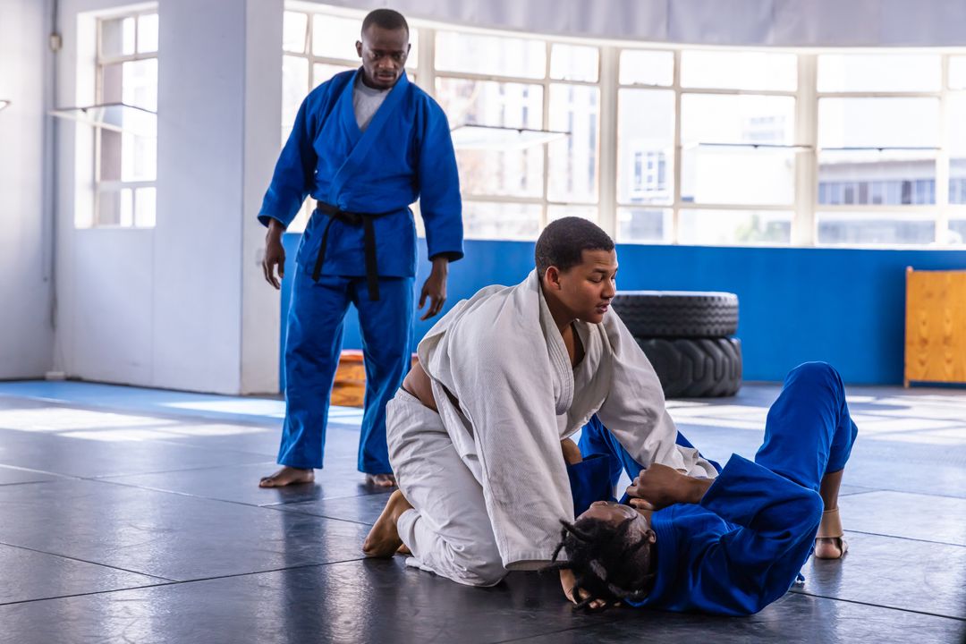 Martial Arts Instructor Supervising Students at Training Session in Gym