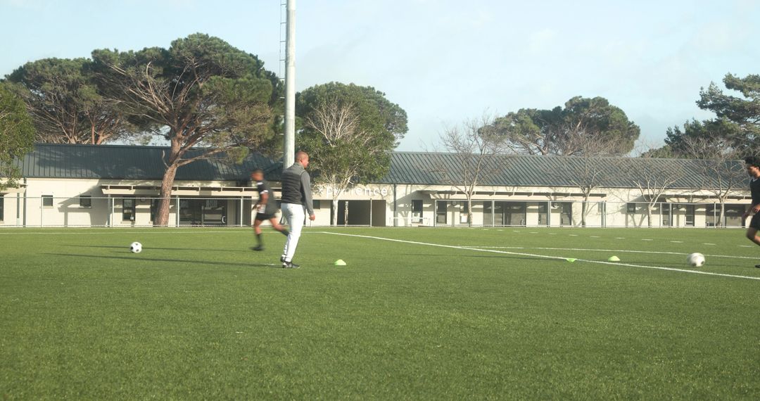 Soccer Players Training on Field Concentrating on Technique