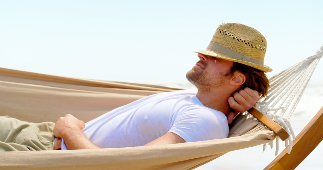 Relaxed Man Resting in Hammock on Sunny Beach - Free Images, Stock Photos and Pictures on Pikwizard.com