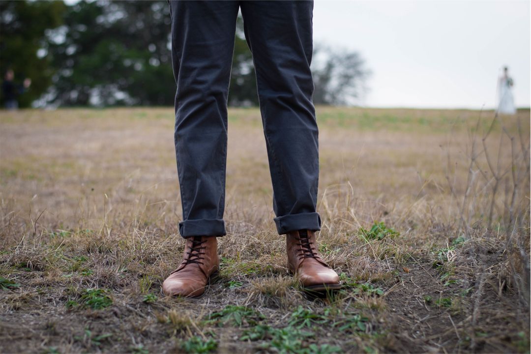 Man Wearing Brown Leather Boots Standing in Field - Free Images, Stock Photos and Pictures on Pikwizard.com