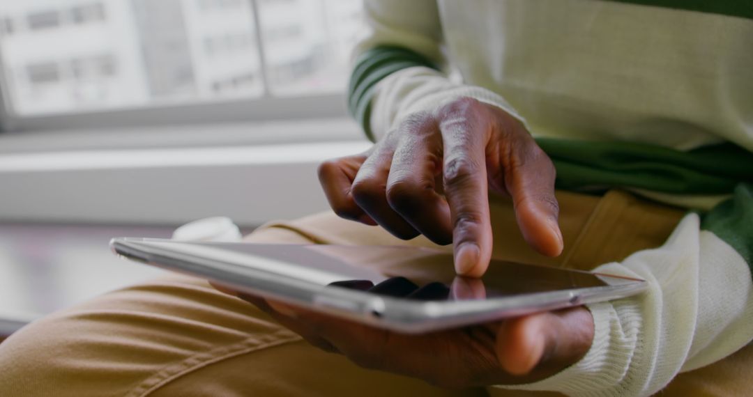 Close-Up of Businessman Using Digital Tablet at Office Window