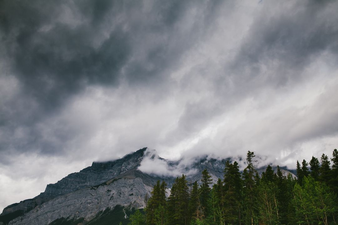 Dark Storm Clouds Over Rocky Mountain Tops - Free Images, Stock Photos and Pictures on Pikwizard.com