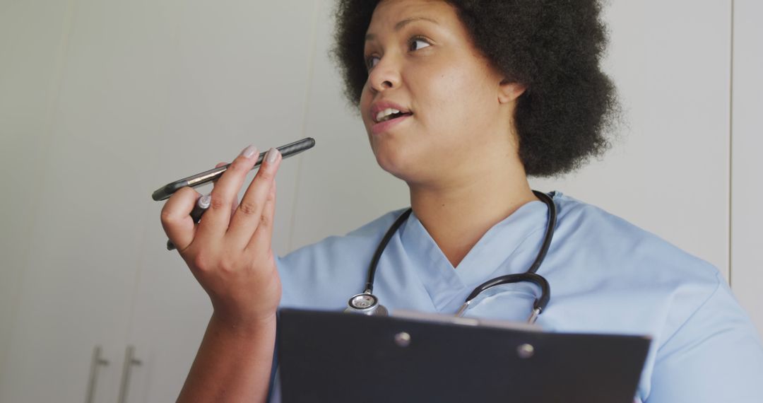 African American Nurse Using Smartphone and Holding Clipboard, Close-up - Free Images, Stock Photos and Pictures on Pikwizard.com