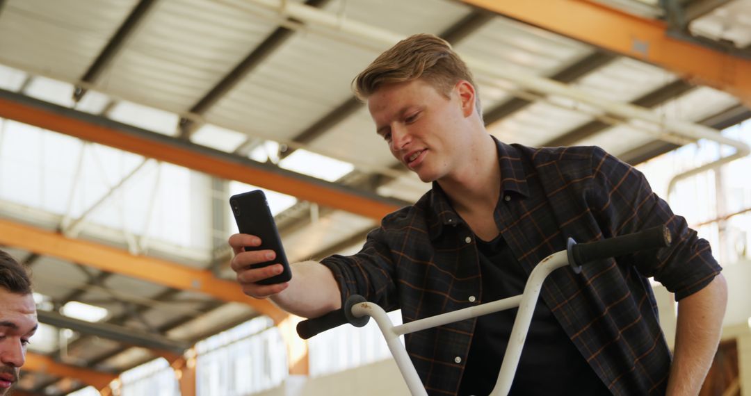 Young Man Taking Selfie on BMX Bike in Industrial Building - Free Images, Stock Photos and Pictures on Pikwizard.com