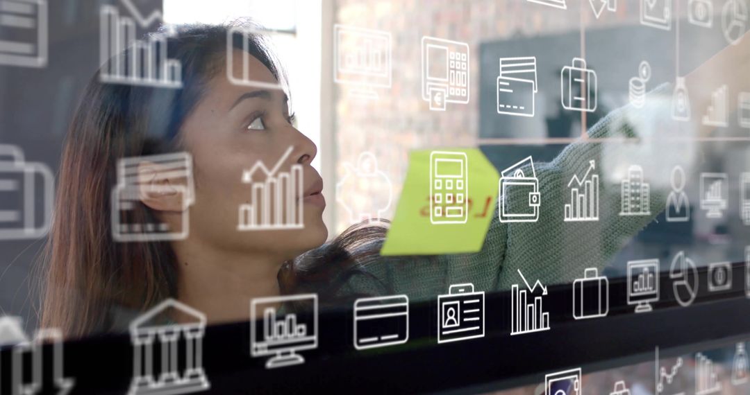 Focused Businesswoman Planning Digital Strategy with Virtual Icons