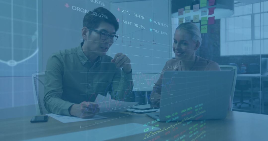 Colleagues Analyzing Financial Data Together in Office Environment