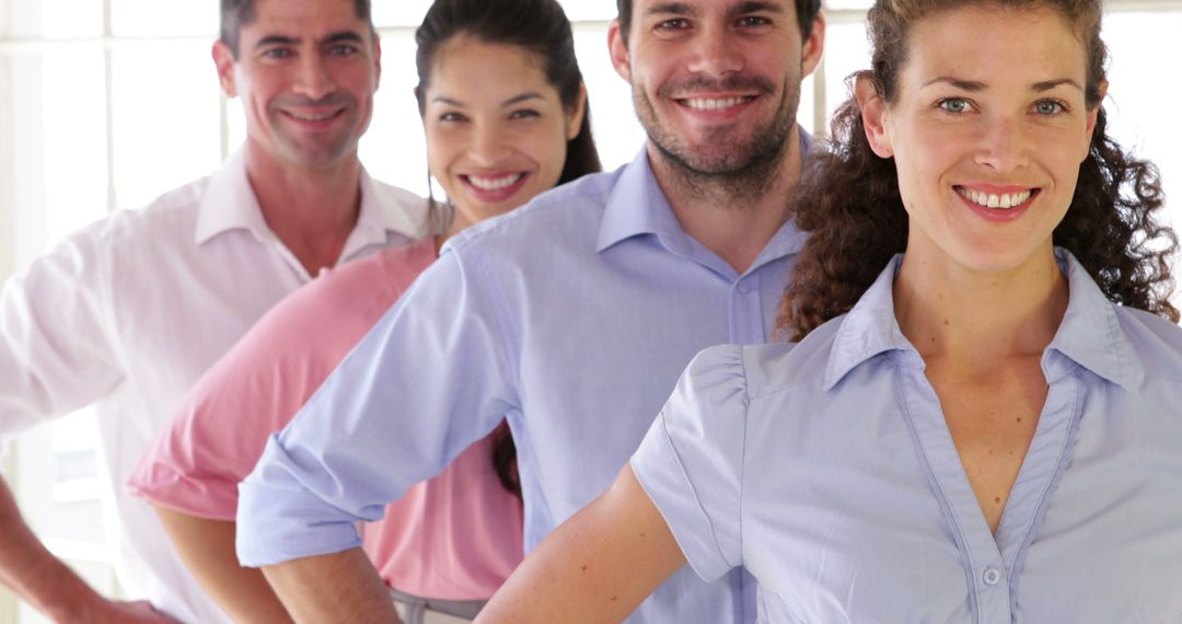 Group of Smiling Professionals Standing in Line With Arms on Hips - Free Images, Stock Photos and Pictures on Pikwizard.com