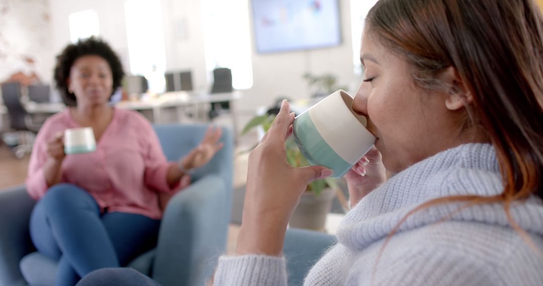 Women Enjoying Coffee While Relaxing and Chatting in Office Lounge - Free Images, Stock Photos and Pictures on Pikwizard.com