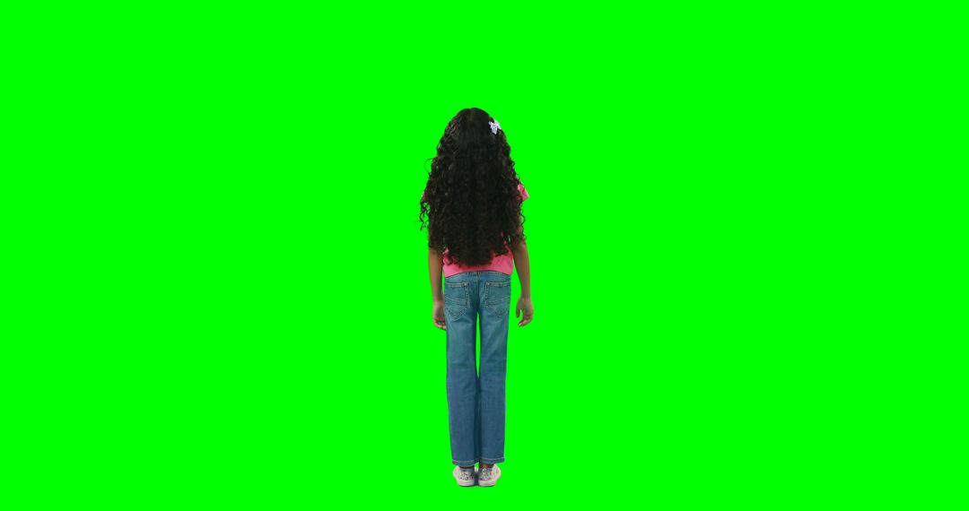 A girl with curly hair stands ready for digital editing against a green screen. - Free Images, Stock Photos and Pictures on Pikwizard.com