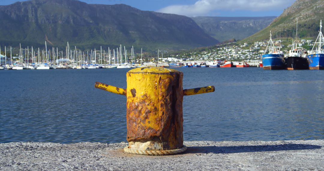 Rusty Bollard on Dock with Boat Marina and Mountain Backdrop - Free Images, Stock Photos and Pictures on Pikwizard.com