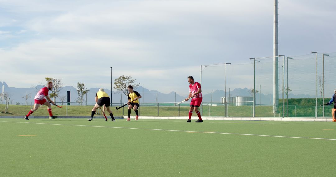 Men Playing Field Hockey Match on Turf During Chilly Day