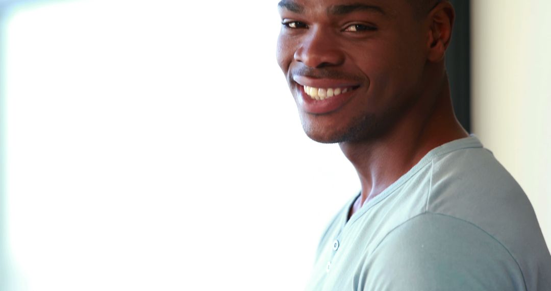 Smiling Young Man in Casual Shirt Looking at Camera - Free Images, Stock Photos and Pictures on Pikwizard.com