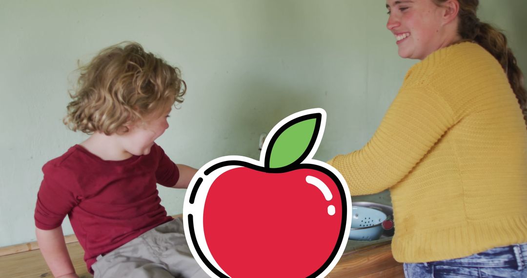 Mother and Son Cooking in Kitchen with Digital Apple Icon Overlay
